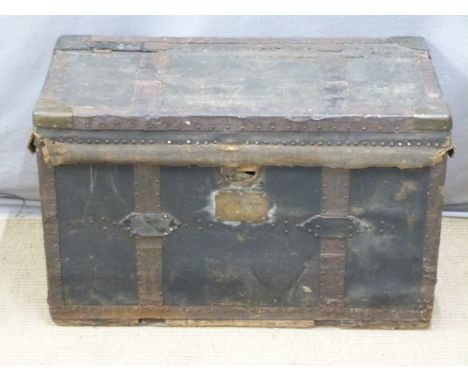 A 19thC fabric covered and lined metal bound trunk with steel drop handles and backplates, the corners brass bound and each i
