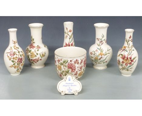 Five Zsolnay Pecs vases, jardiniere and an advertising plaque, tallest 26cm&nbsp;