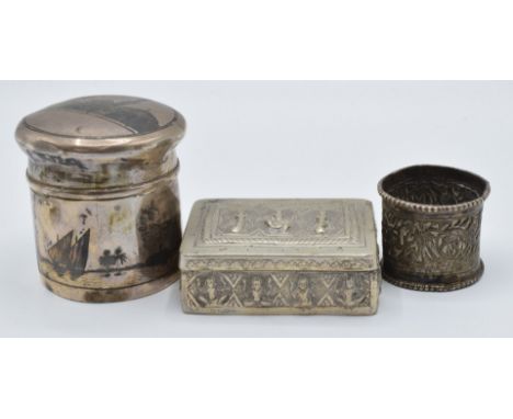 Indian or Burmese white metal napkin ring with embossed decoration of animals and palm trees, embossed white metal box decora