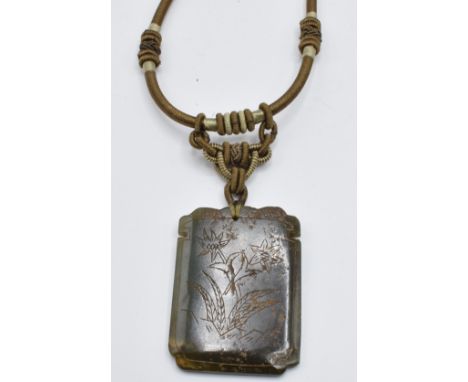 A nephrite jade pendant decorated with character marks and floral scene to verso&nbsp;