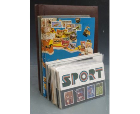 Three albums of stamps including first day covers and presentation packs