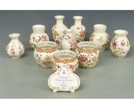 Ten Zsolnay Pecs vases including three with reticulated rims and an advertising plaque, tallest 16cm&nbsp;