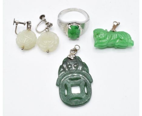 A silver ring set with jadeite, a pair of earrings set with jade and paste and two jadeite pendants&nbsp;