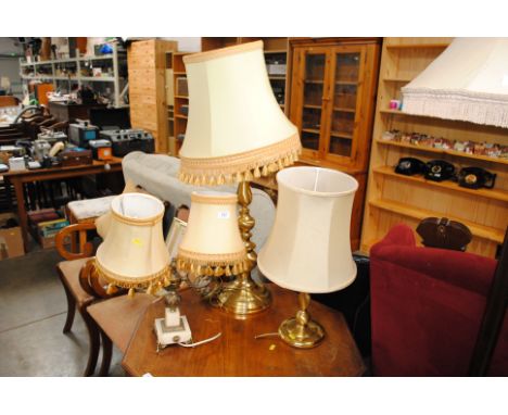 A large brass baluster table lamp and shade, a smaller example and a twin branch onyx and gilt table lamp