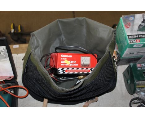 A Gunson 12v automatic battery charger, a windscreen wiper arm pillar, various clamps held within a canvas satchel