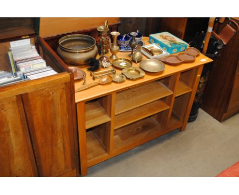 A modern light wood television stand with shelves under 