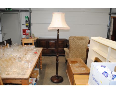 A mahogany standard lamp and shade 