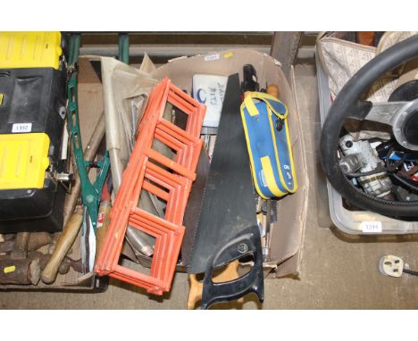 A box containing various tools to include hand saws, a cased boules set, bow saw, hand axe, collapsible wooden wine rack etc.