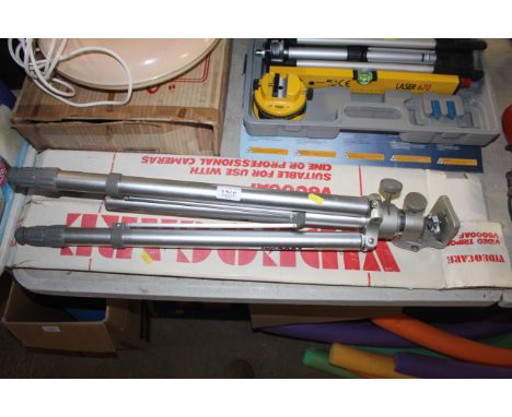 A vintage camera tripod with original box