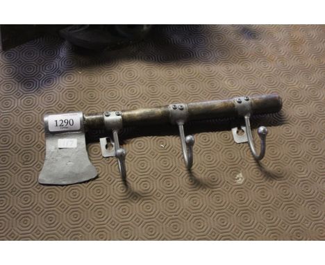 A three hook coat rack in the form of an axe (117)