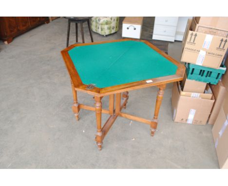 A walnut fold over card table with baize lined top