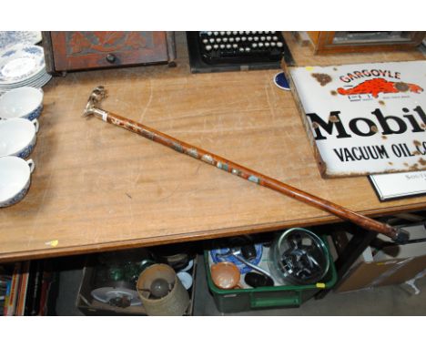 A souvenir walking stick with Jaguar mascot handle 