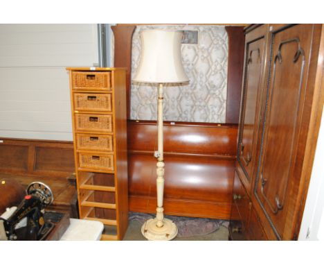 A cream painted standard lamp and shade