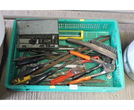 A tray containing various tools to include wire brush, various files, drill bits, caulk gun