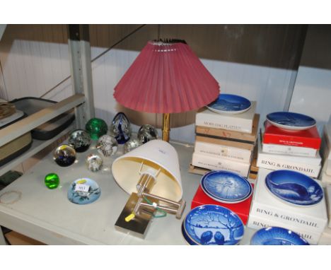 A brass table lamp with shade and a wall lamp