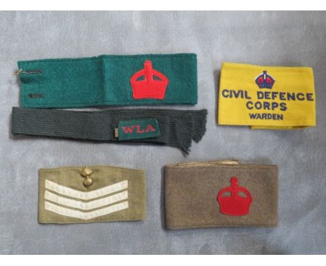 A WWI DERBY SCHENE ARMBAND, along with a Women's Land Army armband &amp; title and two later armbands