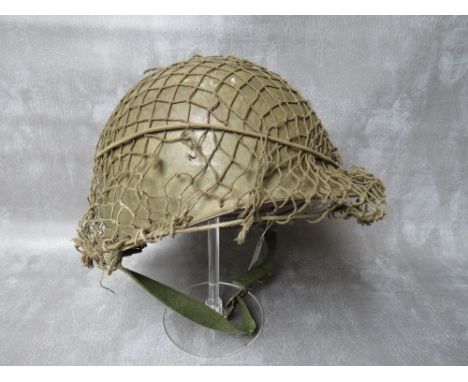 A US ARMY VIETNAM ERA TIN HELMET AND LINER 