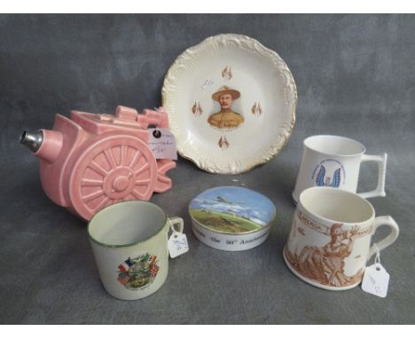 A BOX OF MILITARY INTEREST CERAMICS, to include a cannon teapot, a Dudley peace mug 1919 and a Beden Powell plate