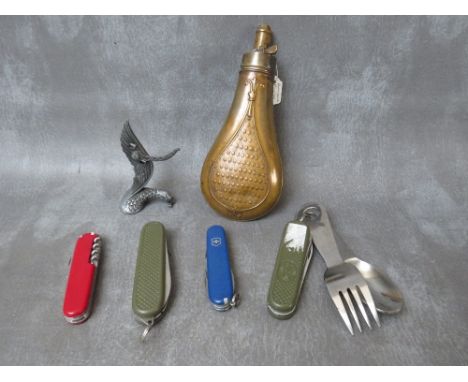 AN ANTIQUE COPPER POWDER FLASK, with embossed decoration and a quantity of pen / pocket knives