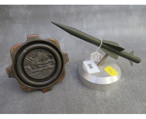 A 1915 LUSITANIA MEDAL, set into a dish, along with a bull ring and a rapier missile paperweight