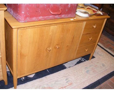 A light oak sideboard consisting of two door cupboard and three drawers - width 135cms