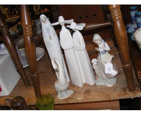 A Lladro figure of girl feeding pigeons, together with other Lladro and Nao 