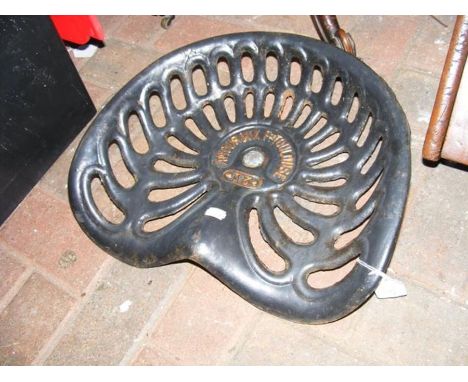 A vintage cast metal tractor seat by Amouroux Toulouse 