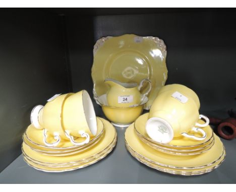 A vintage part tea service by Tuscan in striking mustard yellow