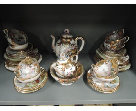A vintage egg shell part tea service made in Japan with hand decorated finish