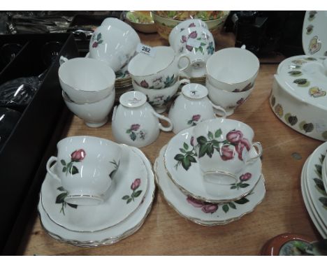A selection of vintage tea cups and saucers with transfer prints