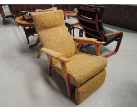 A vintage beech frame recliner armchair having moquette upholstery