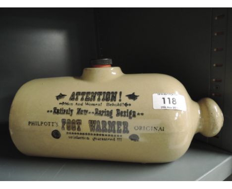 A vintage stoneware ceramic foot warmer with transfer print