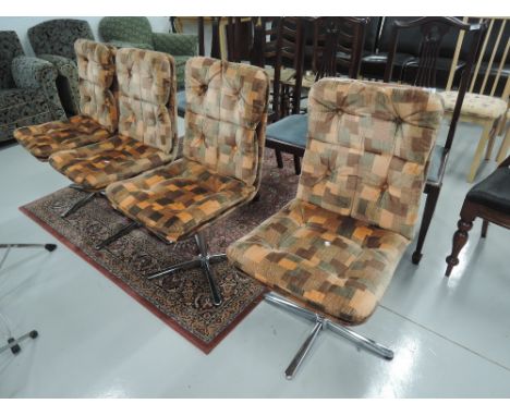 A set of four vintage dining chairs, chrome frame revolving