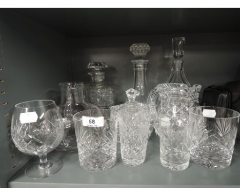 A selection of vintage clear cut crystal and leaded glass wares including decanters 