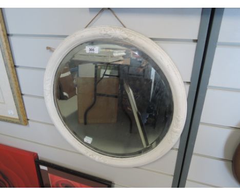 A vintage circular mirror with period frame