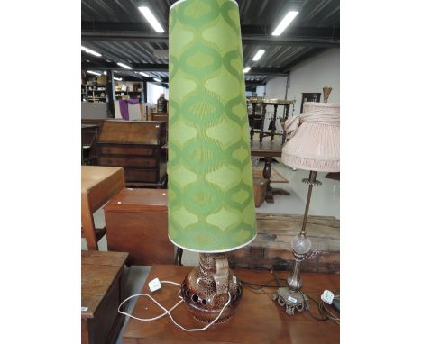 A vintage floor lamp with stylised 60s/70s shade