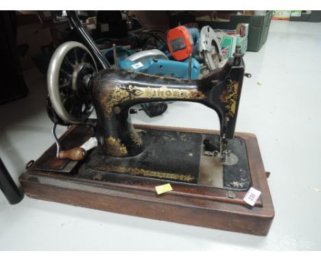 A vintage sewing machine by singer hand cranked with case