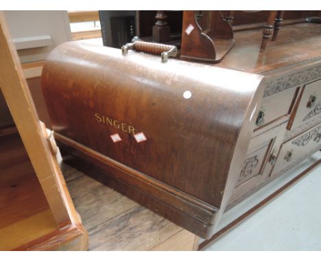 A vintage Singer sewing machine in wood case