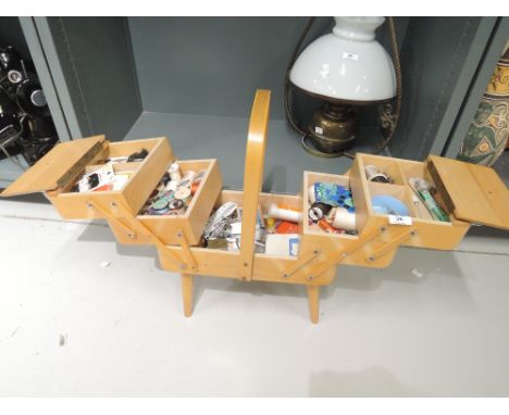 A selection of vintage sewing crafts and haberdashery items in case