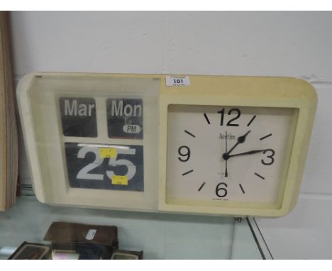 A vintage 1970's wall clock and date callendar