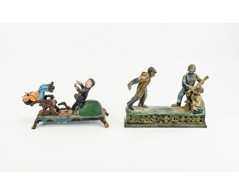 Vintage Cast Iron Money Boxes Two cold painted novelty money boxes, the first with a baseball theme featuring pitcher and str