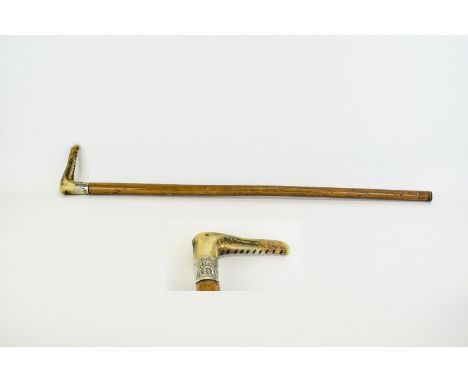 Walking Stick  Fashioned in wood with carved bone handle and silver tone collar. Approx length 32 inches