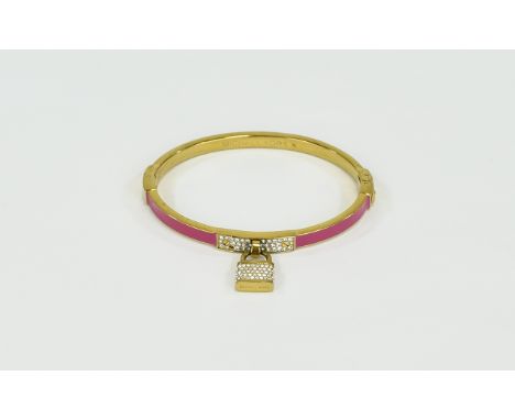 Michael Kors Enamel And Crystal Set Bangle. Pink enamel on gold tone metal with tiny crystal set padlock detail