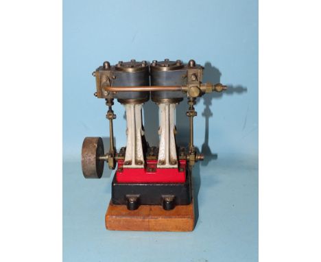 A Stuart Turner "Double 10" vertical twin-cylinder engine on wood base, 16.5cm high. 