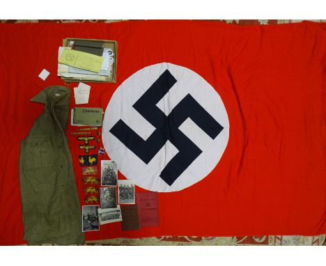 A Third Reich Nazi flag, red cotton with printed black swastika on white cotton ground, 116 x 190cm, two WWII German Navy clo