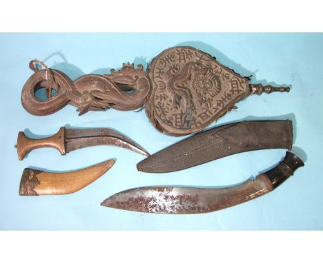 A pair of Chinese carved hardwood bellows, a kukri knife, an Indian hide or leather dahl shield (in poor condition) and an In