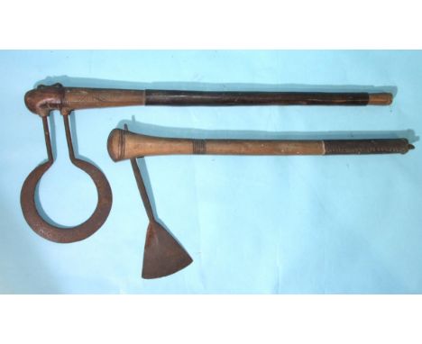 An unusual African axe, the iron hoop blade with engraved decoration and inserted through the shaft, 68cm and another with le