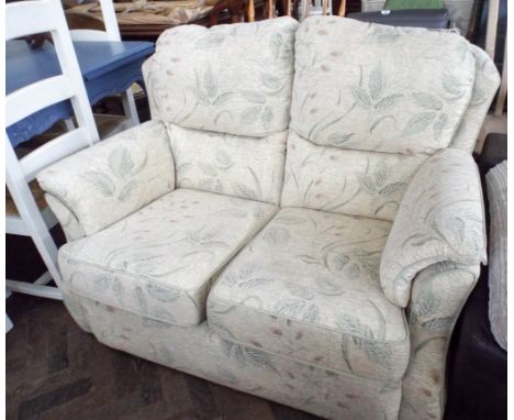 A small G Plan two seater sofa in a floral beige chenille