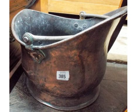 A Victorian copper coal helmet 