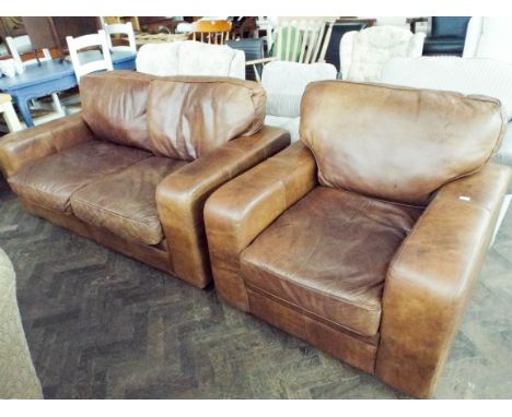 An antiqued brown leather two seater sofa and one matching armchair 